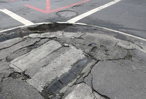 damaged sidewalk due to overuse