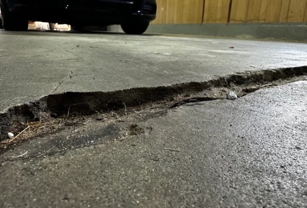 Visible cracks on a concrete garage floor.