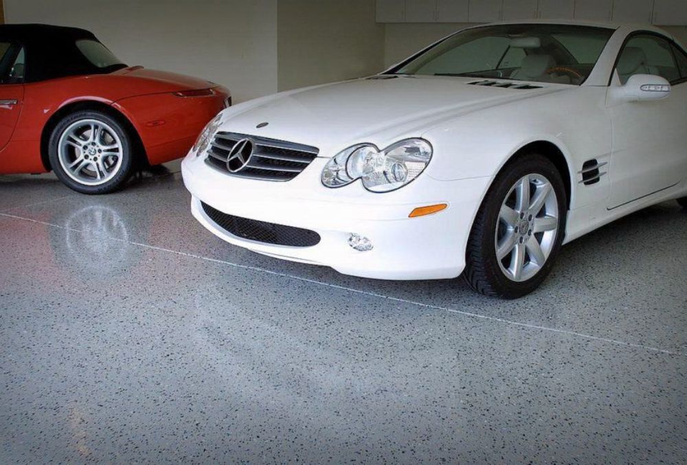 Residential garage in Seattle featuring sealed concrete floor and two parked cars