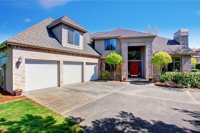 3 door garage with concrete driveway