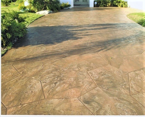 Residential driveway with decorative concrete overlay and textured stone-like finish