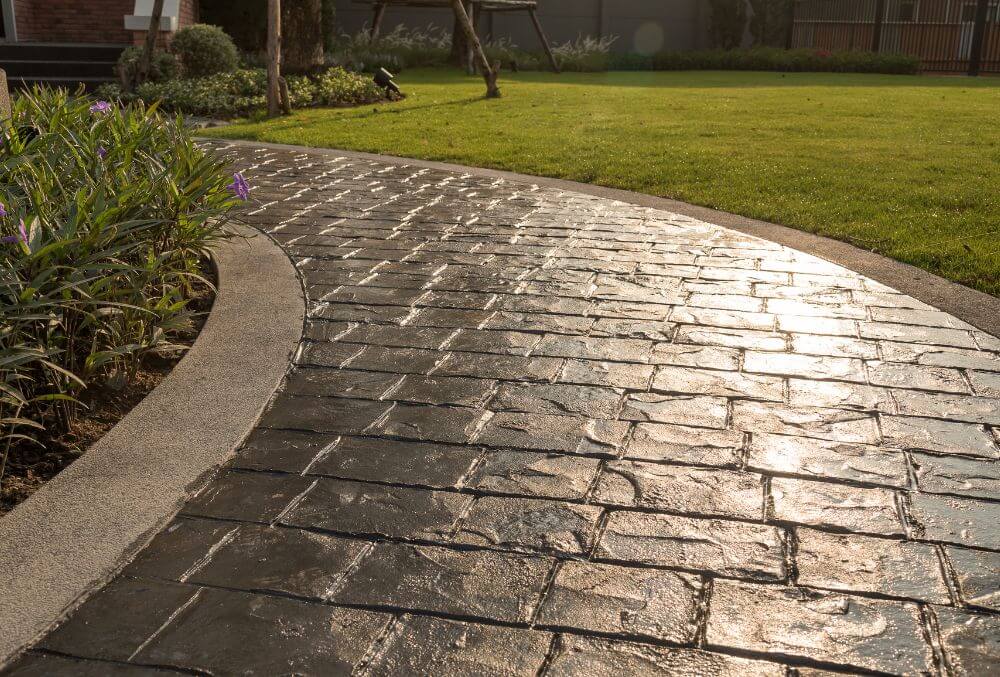 gray colored stamped concrete floor and a green lawn