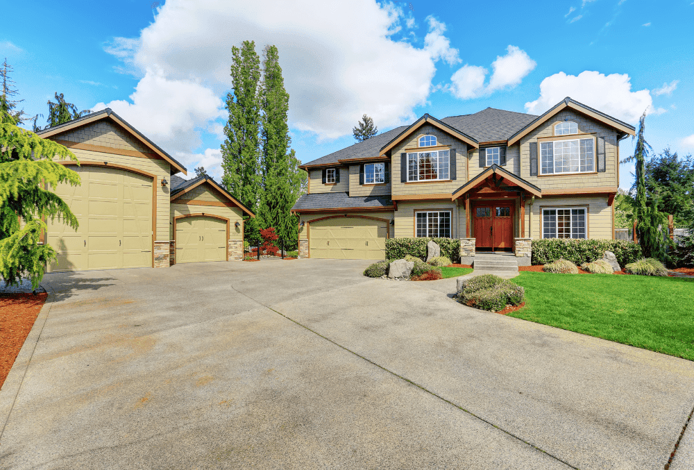 concrete driveway with a beautiful landscape