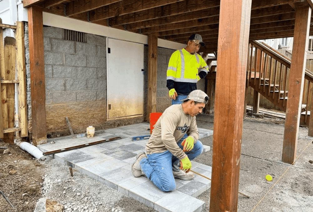 Professional contractor renovation team working on a modern home interior with tools and equipment.