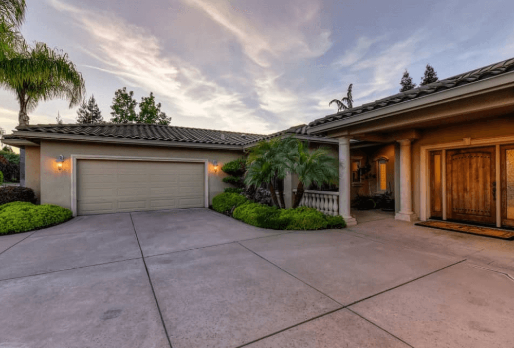 Residential garage with a concrete driveway in front