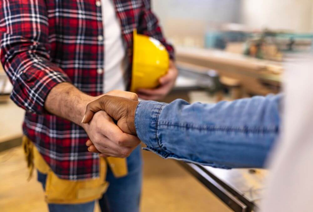 Contractor and business owner shaking hands