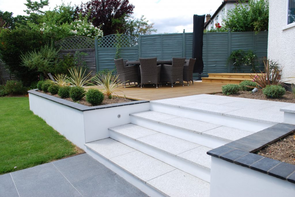 Concrete deck with stairs featuring a durable, slip-resistant surface and decorative finish, providing a seamless transition between outdoor levels.