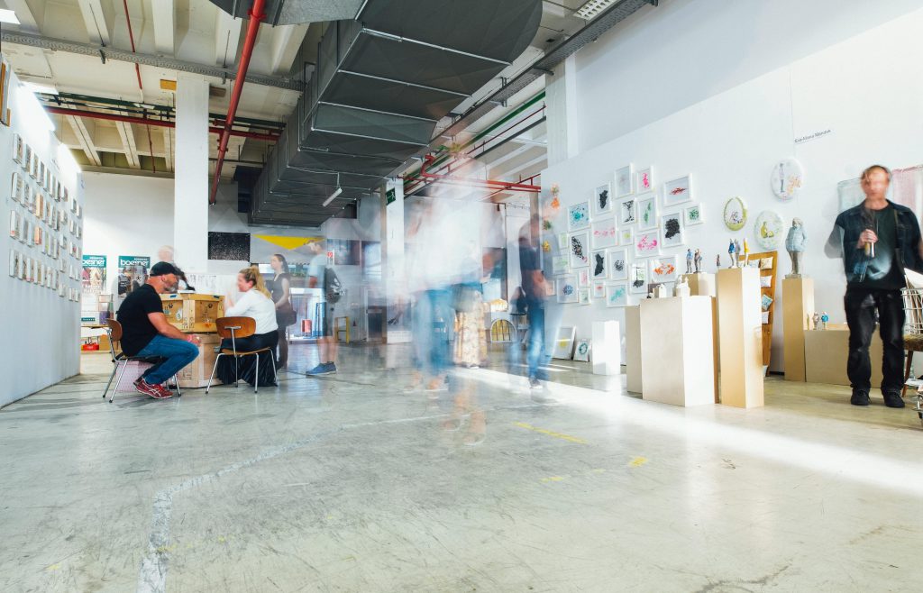 Modern commercial space with polished epoxy concrete floor and people walking through the area