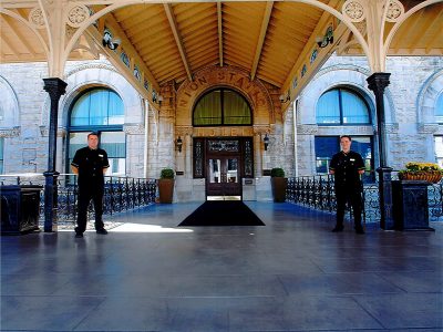 Elegant building exterior entrance with stamped concrete flooring and decorative columns