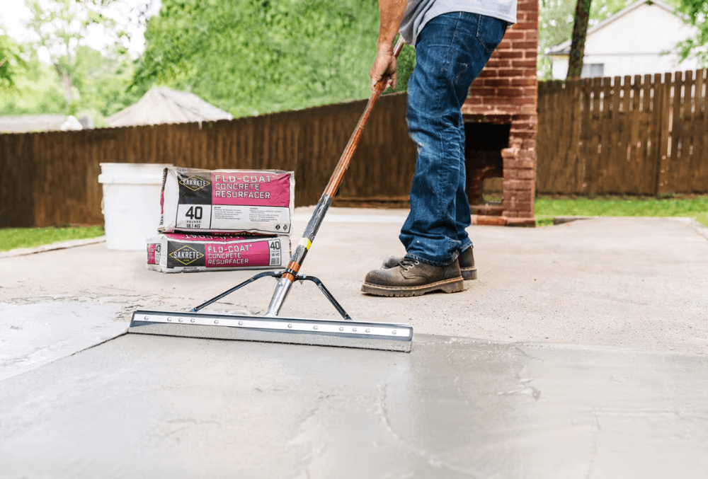 contractor applying concrete overlaying using tools
