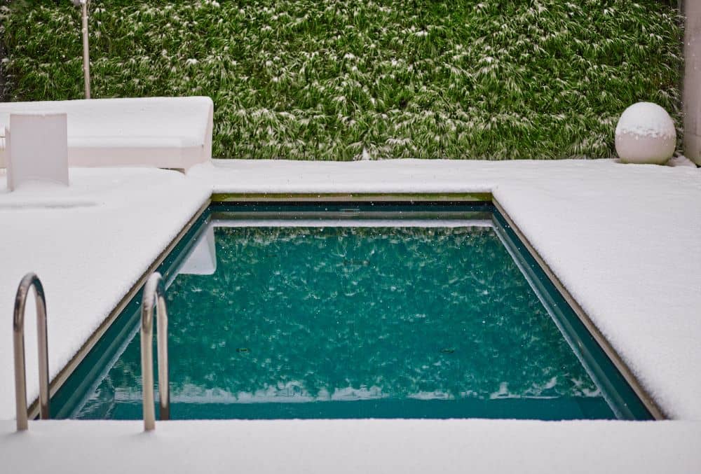 pool with snow on the deck