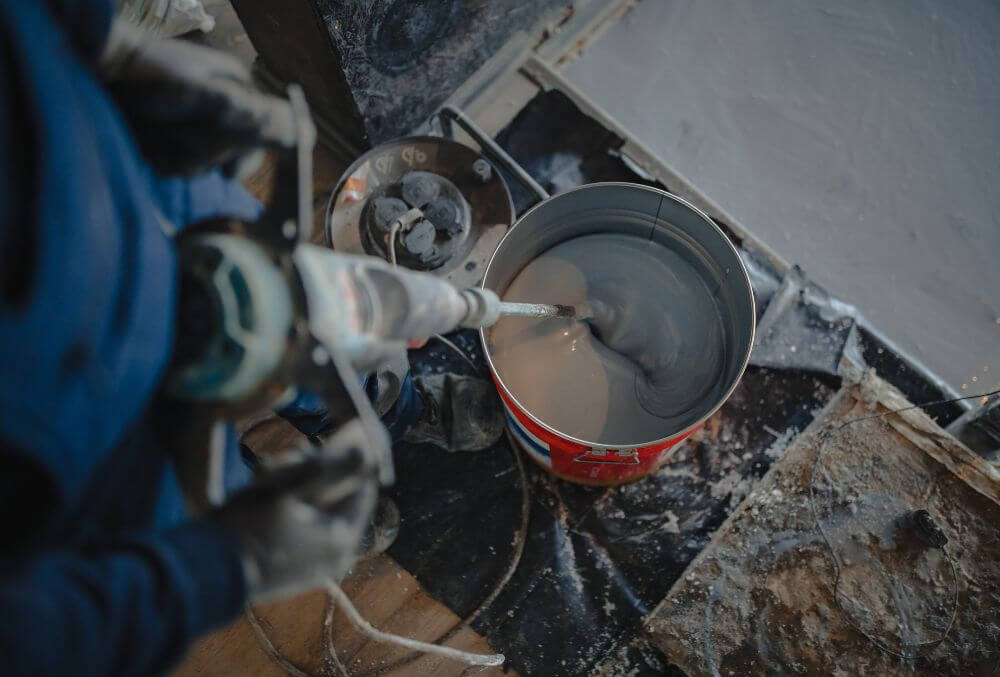 man mixing the epoxy coating