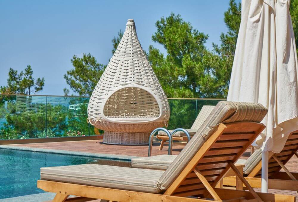 Nordic-designed chairs by the concrete pool deck