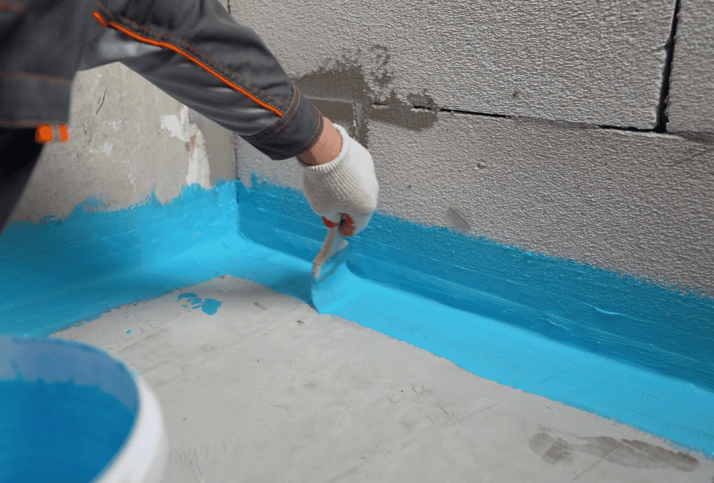 man waterproofing the concrete